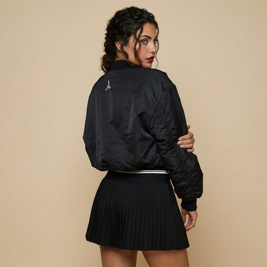 Back view of women’s black padded tennis bomber jacket with embroidered logo – Noir Court Collection