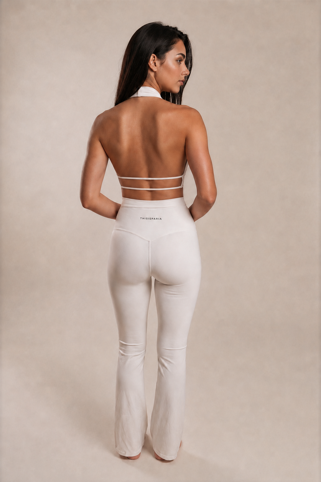 Back view of the Ivory Twist Flare Set showing the open-back halter top with two slim straps and high-waisted flared leggings.