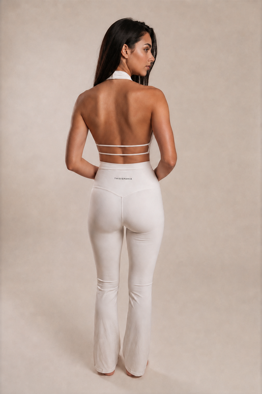 Back view of the Ivory Twist Flare Set showing the open-back halter top with two slim straps and high-waisted flared leggings.