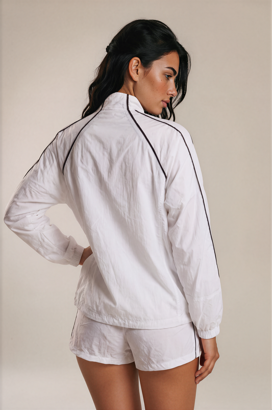 Back view of woman wearing the white Aero Court Set with black contrast piping