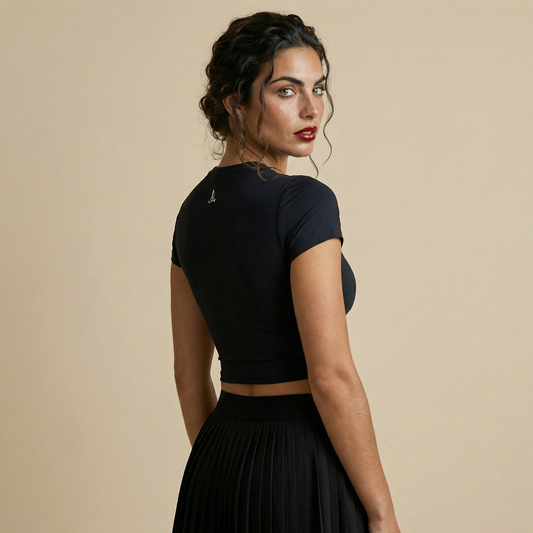 Back view of black short sleeve body-contouring padel top with subtle logo detail at neckline.