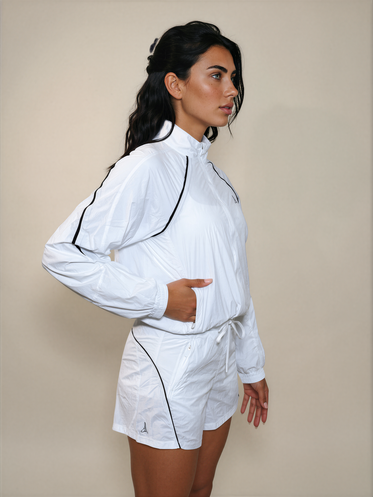 Side view of white Aero Court Set with lightweight zip jacket, shorts and side pockets